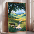 A large framed painting depicting a serene landscape with a bench in the foreground, surrounded by a lush green field and a winding path leading to a tree with a large canopy.
