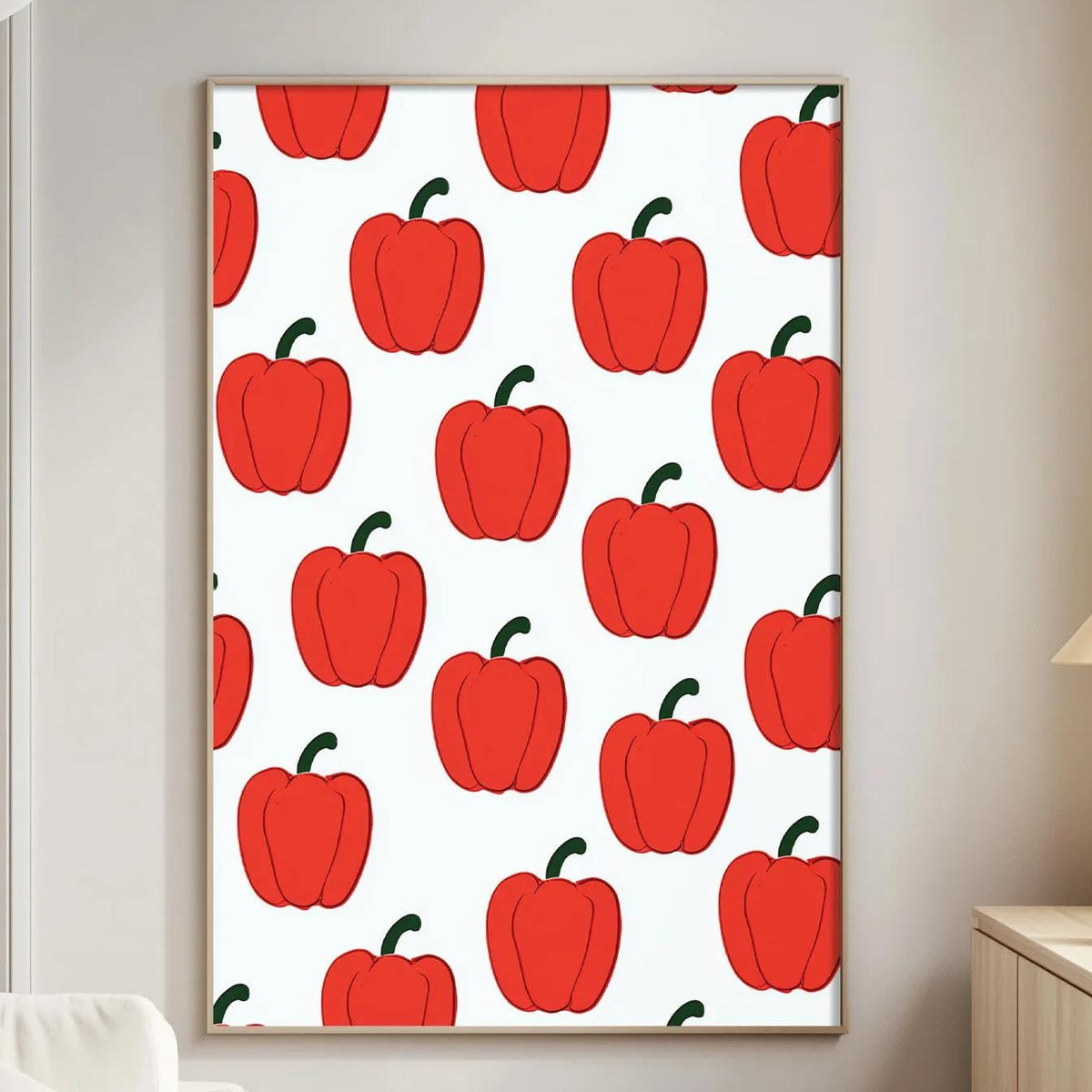 a living room with a white sofa, a wooden side table, and a framed print of red peppers on the wall.