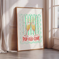 A framed poster with a graphic design of two champagne glasses clinking together, surrounded by a wavy pattern and the text "POP-Fizz-CLINK".