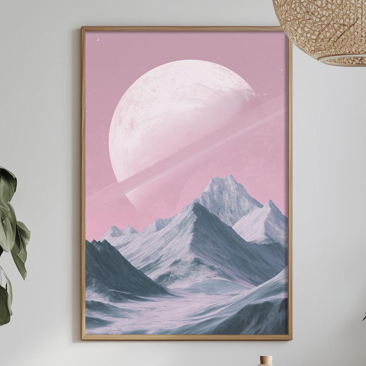 a dining table with a white tablecloth, a bowl of fruit, a bottle, and a vase with flowers. Above the table, there is a framed picture of a mountain landscape with a large moon in the sky.