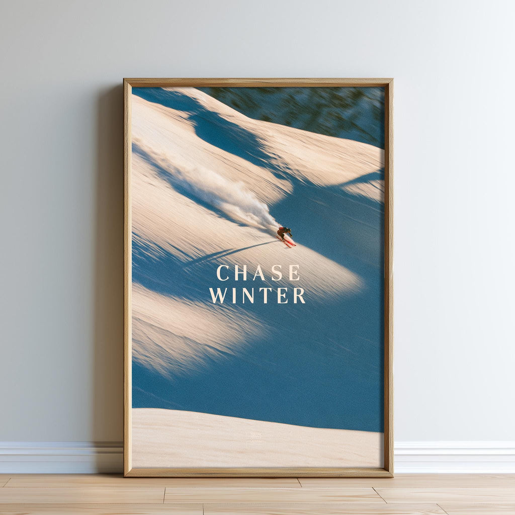 A framed photograph of a person snowboarding down a snowy mountain slope, with the text "CHASE WINTER" prominently displayed.
