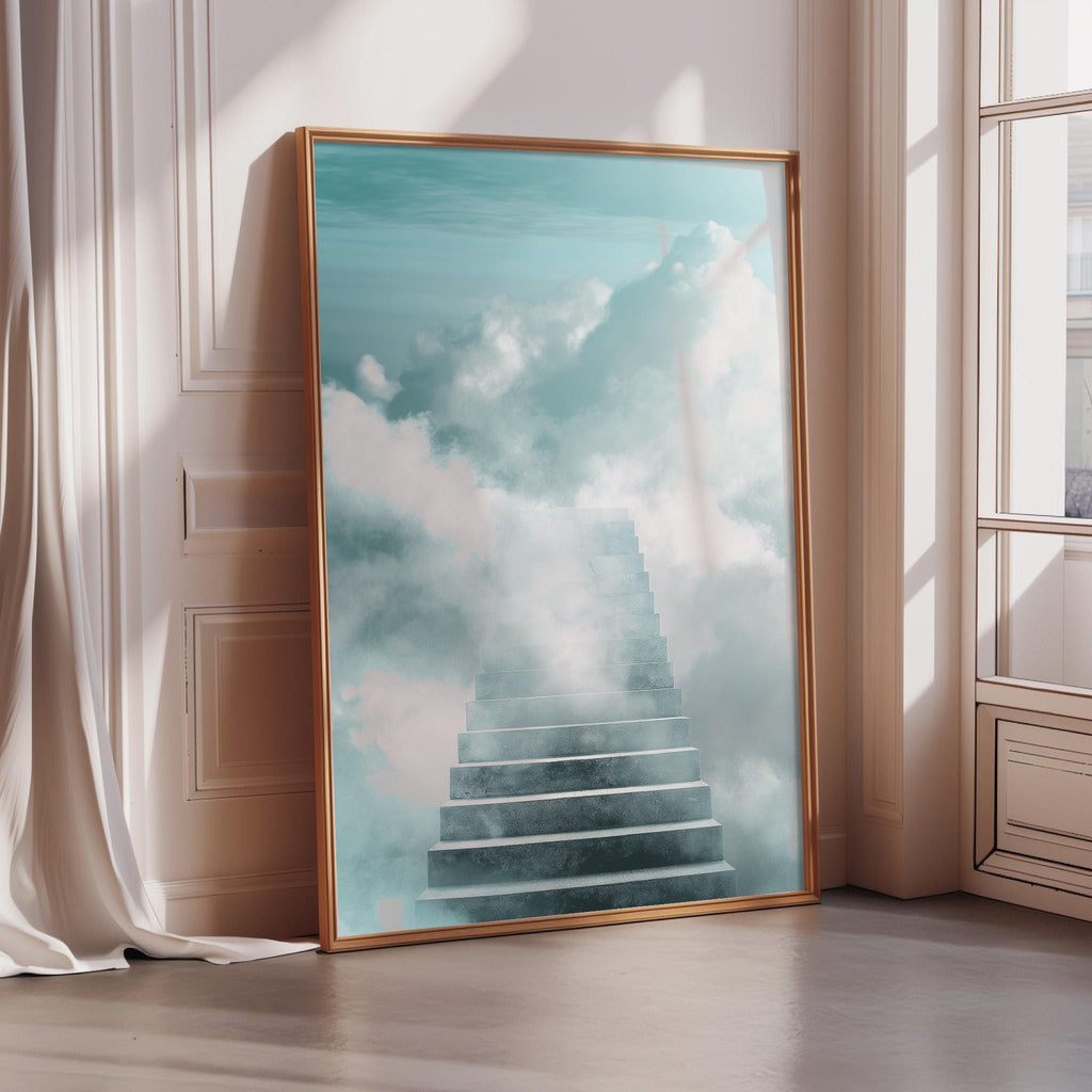 a large framed picture of a staircase leading up to a sky with clouds, placed on a wooden floor in a room with a window.