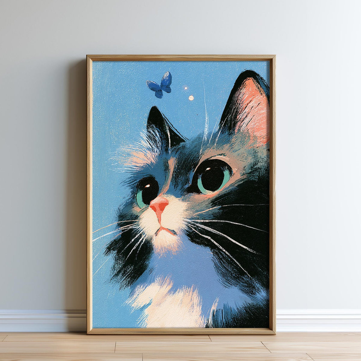 A framed painting depicting a close-up of a cat's face with large, expressive eyes and a pink nose, set against a blue background with two small white dots.