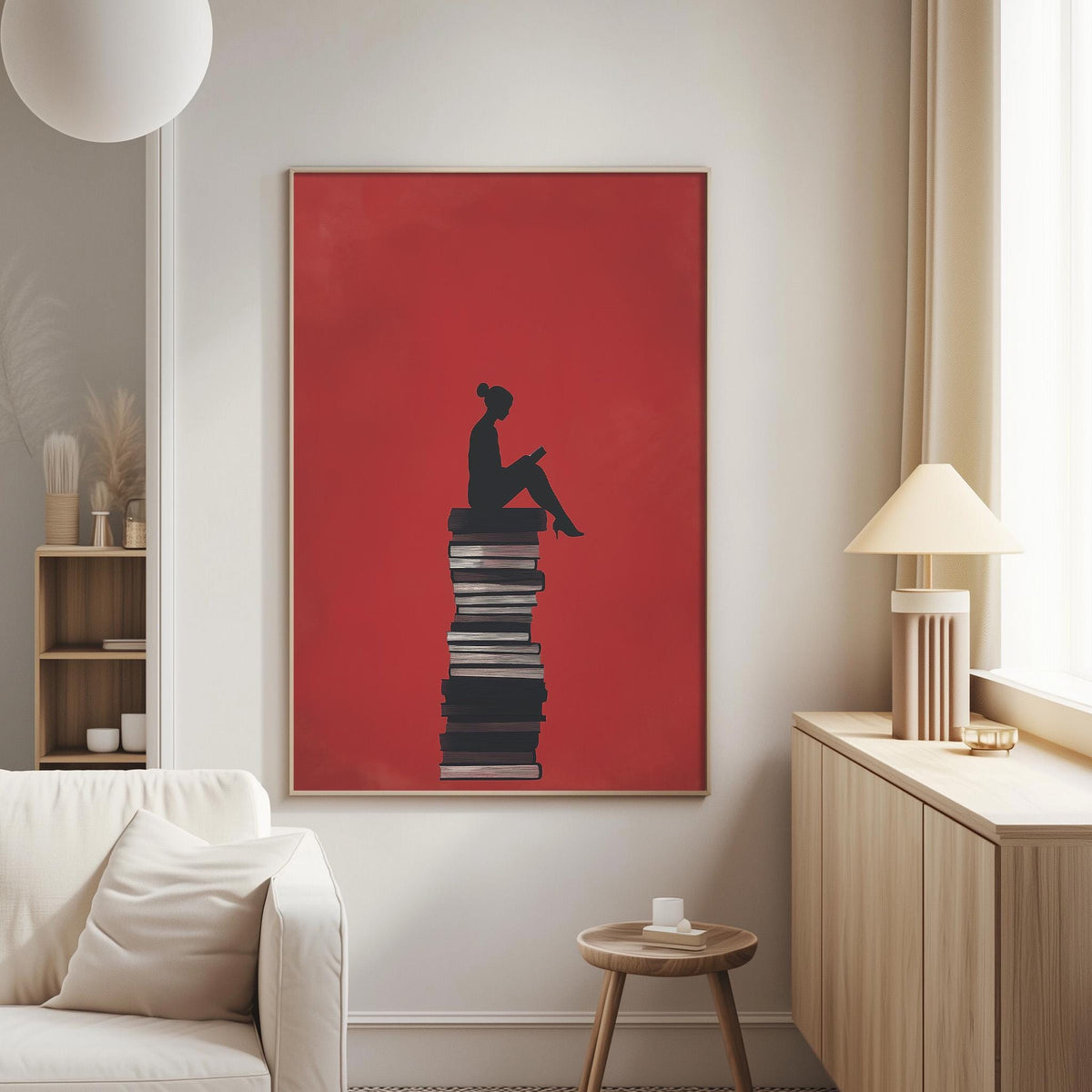 a cozy living room with a large red poster featuring a silhouette of a person sitting on a stack of books, which is the focal point of the room.