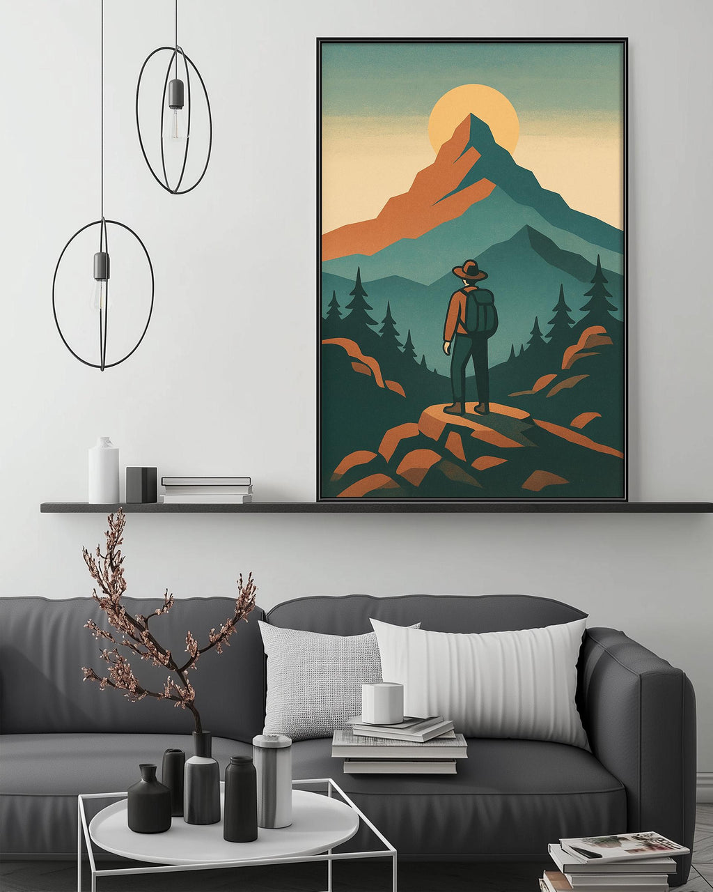 a cozy living room with a gray couch, a coffee table, and a large framed illustration of a hiker standing on a rocky cliff overlooking a mountain landscape.