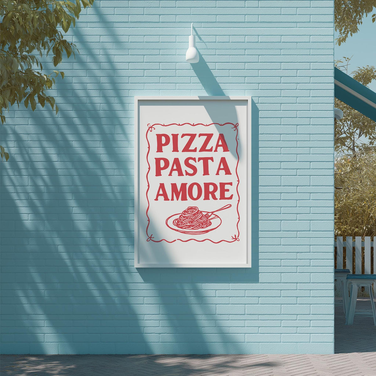 A framed sign on a blue wall that reads "PIZZA PASTA AMORE" with a picture of spaghetti and meatballs below it.