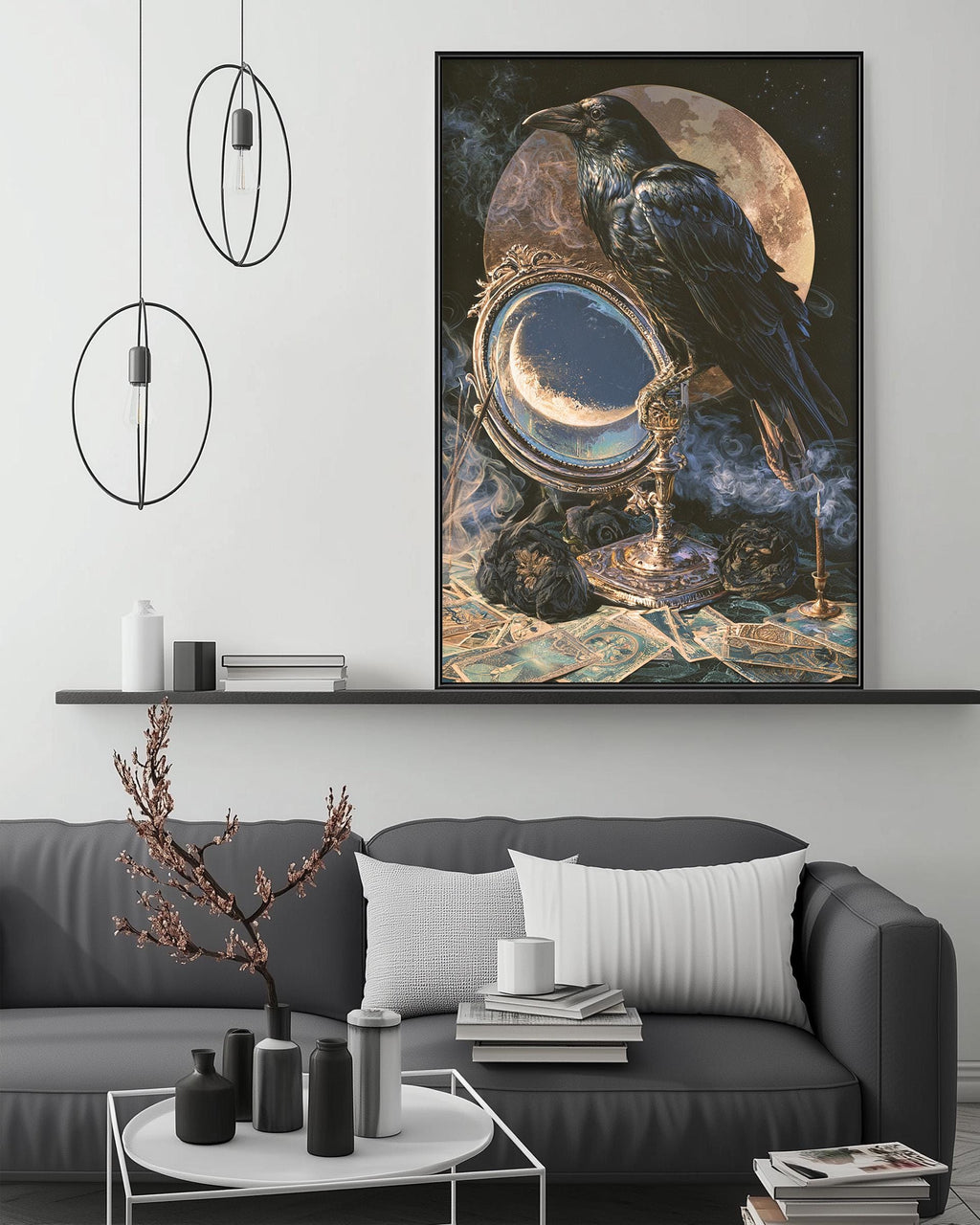a large framed painting of a black crow perched on a crescent moon, surrounded by various objects such as a mirror, a candle, and a vase. The painting is displayed on a wall above a gray couch, which is positioned in front of a coffee table. The overall scene appears to be a cozy and artistic living space.