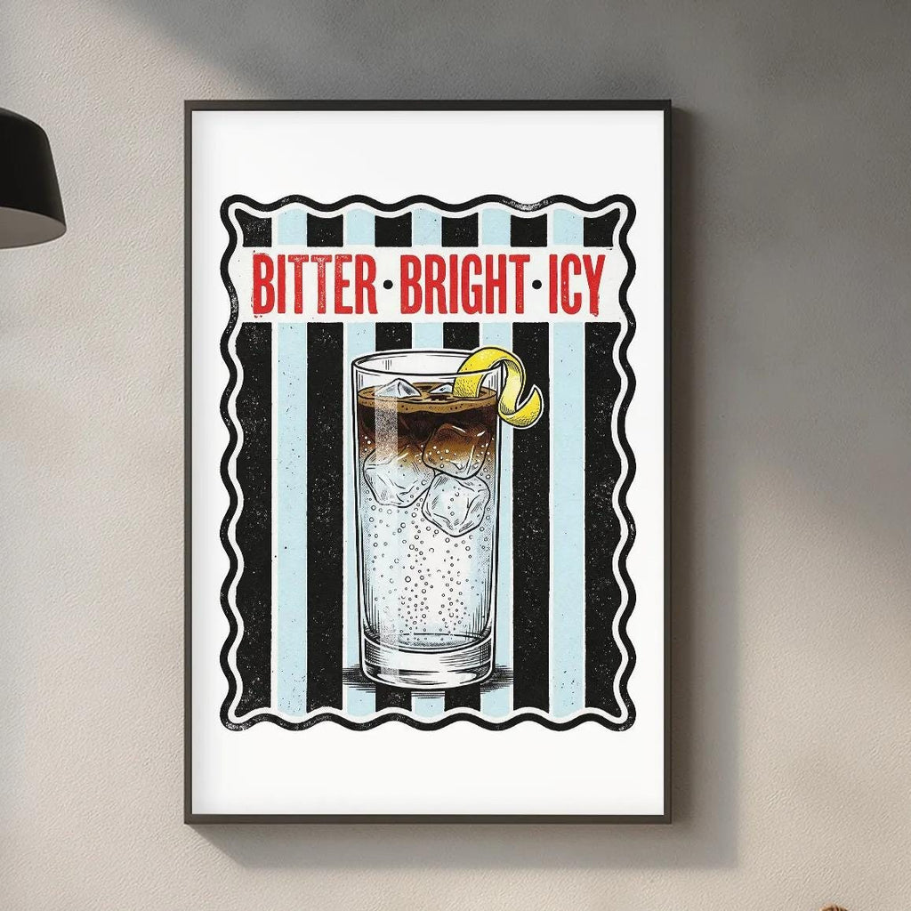 a framed poster of a glass with ice and lemon slices, hanging on a wall above a kitchen counter.