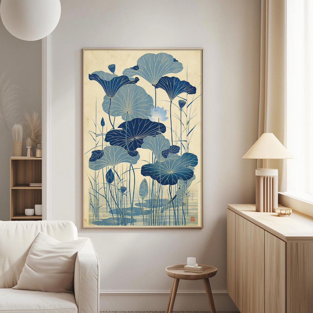 a living room with a large framed artwork of blue lotus flowers hanging on the wall. The artwork is the focal point of the room, and it is positioned above a white couch. The room also includes a small table and a lamp, creating a cozy and inviting atmosphere.
