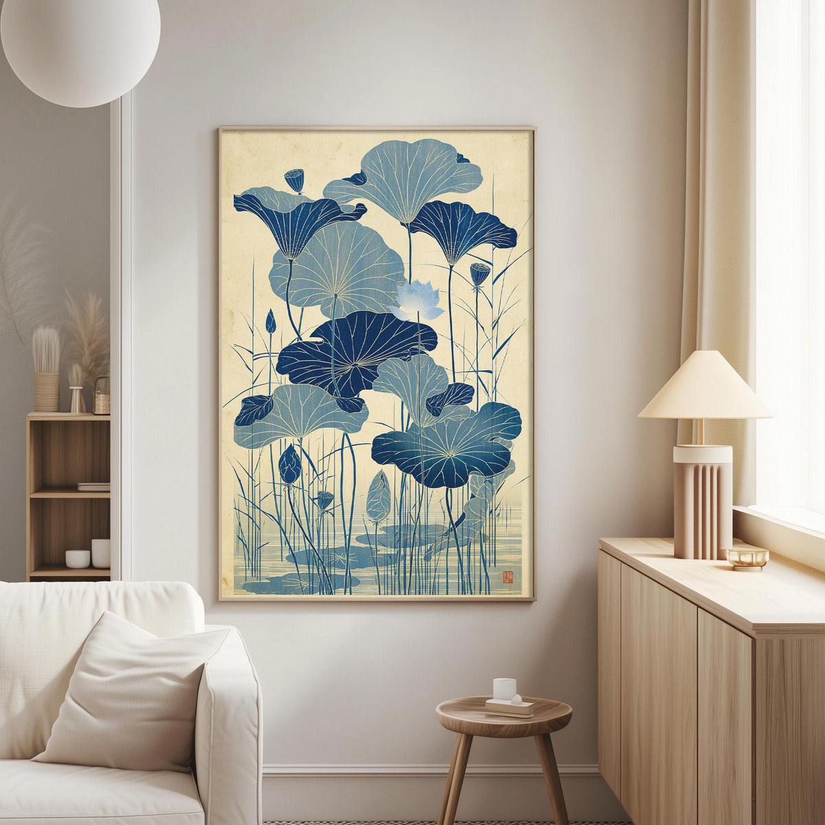a living room with a large framed artwork of blue lotus flowers hanging on the wall. The artwork is the focal point of the room, and it is positioned above a white couch. The room also includes a small table and a lamp, creating a cozy and inviting atmosphere.