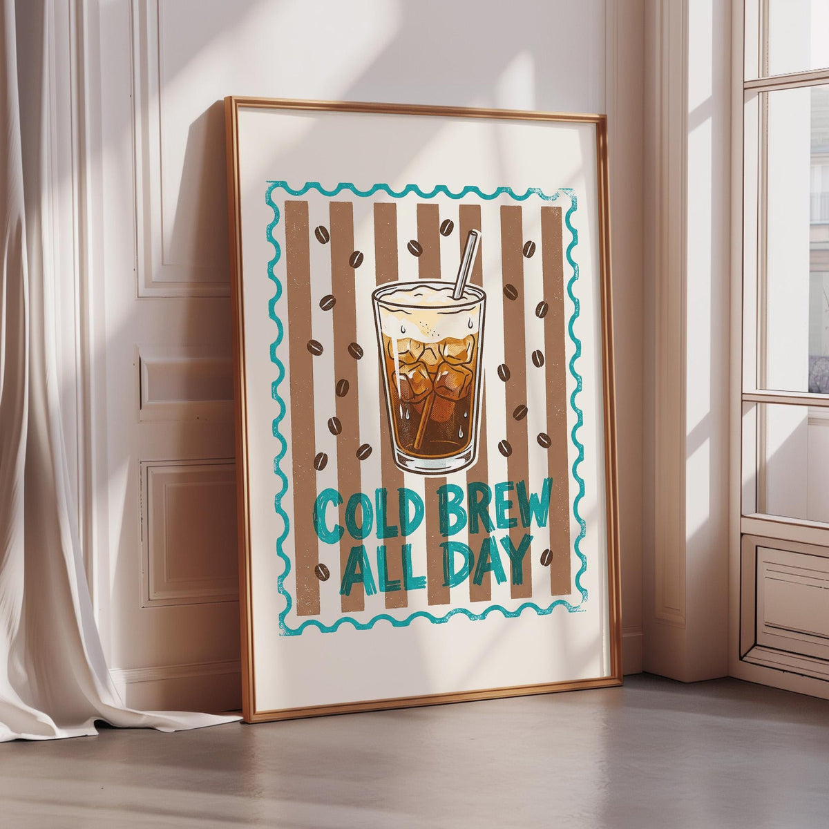 A framed poster with a picture of a glass of iced coffee and the text "COLD BREW ALL DAY" on it, placed on a wall near a window.