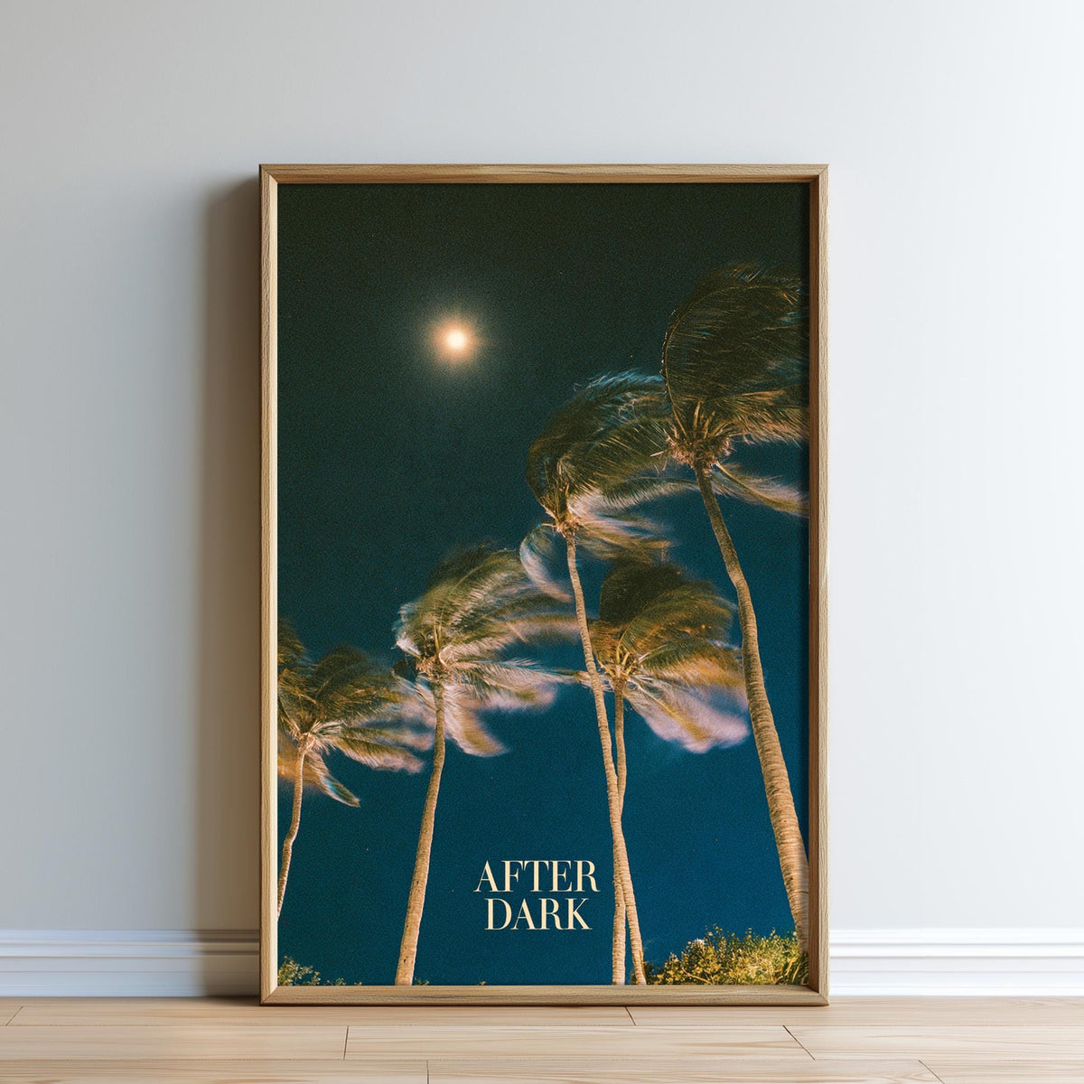 The image is a framed poster depicting a night scene with palm trees swaying in the wind, and a bright moon in the sky.