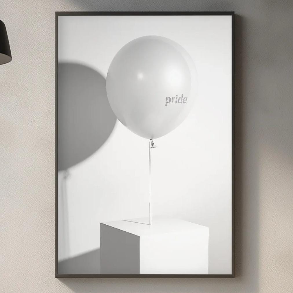 a minimalist kitchen scene with a framed picture of a white balloon with the word "pride" on it, a wooden cutting board, and various kitchen items such as a sink, a bottle, and a vase.