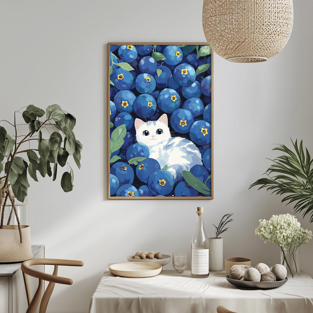 a framed painting of a cat surrounded by blueberries, with a dining table and chairs in the foreground.