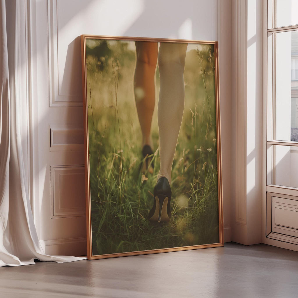 A large framed photograph of a person's legs and feet in a grassy field, with the person's reflection visible in the glass.
