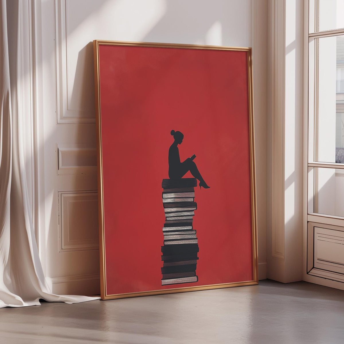 A large framed poster depicting a silhouette of a person sitting on a stack of books, with a red background.