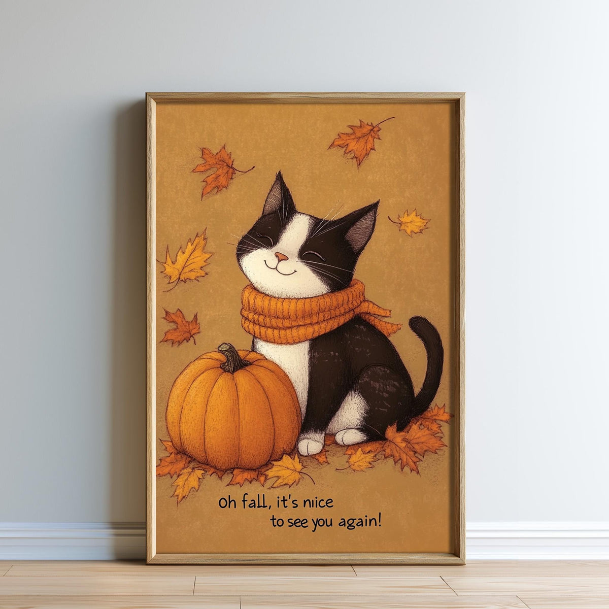 A framed illustration of a black and white cat sitting next to a pumpkin, surrounded by autumn leaves, with the text "oh fall, it's nice to see you again!"