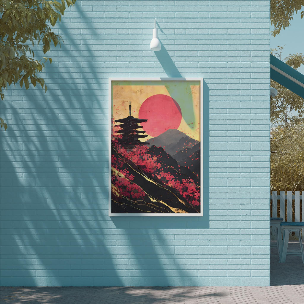 a framed painting of a pagoda against a backdrop of a red sun and mountains, hanging on a blue wall.