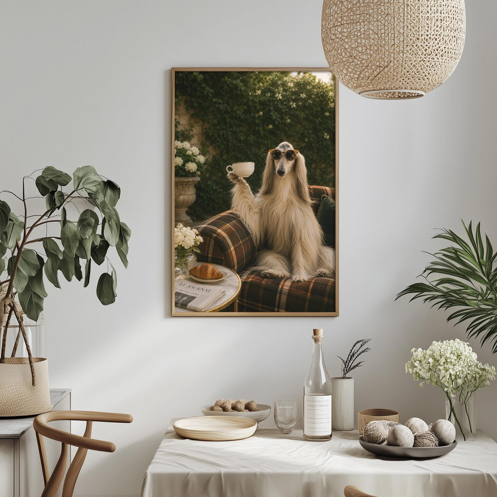 a large framed picture of a dog sitting on a couch, holding a cup in its mouth, with a dining table and various decorative items in the foreground.