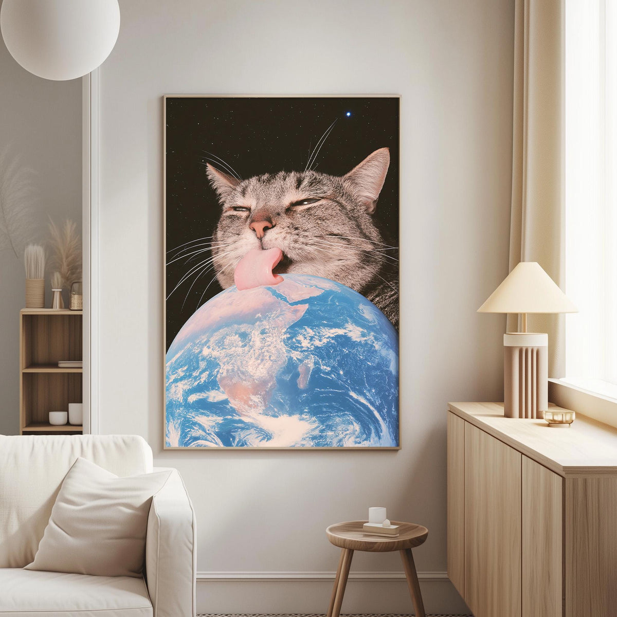 a large framed picture of a cat licking a globe, which appears to be a representation of the Earth.