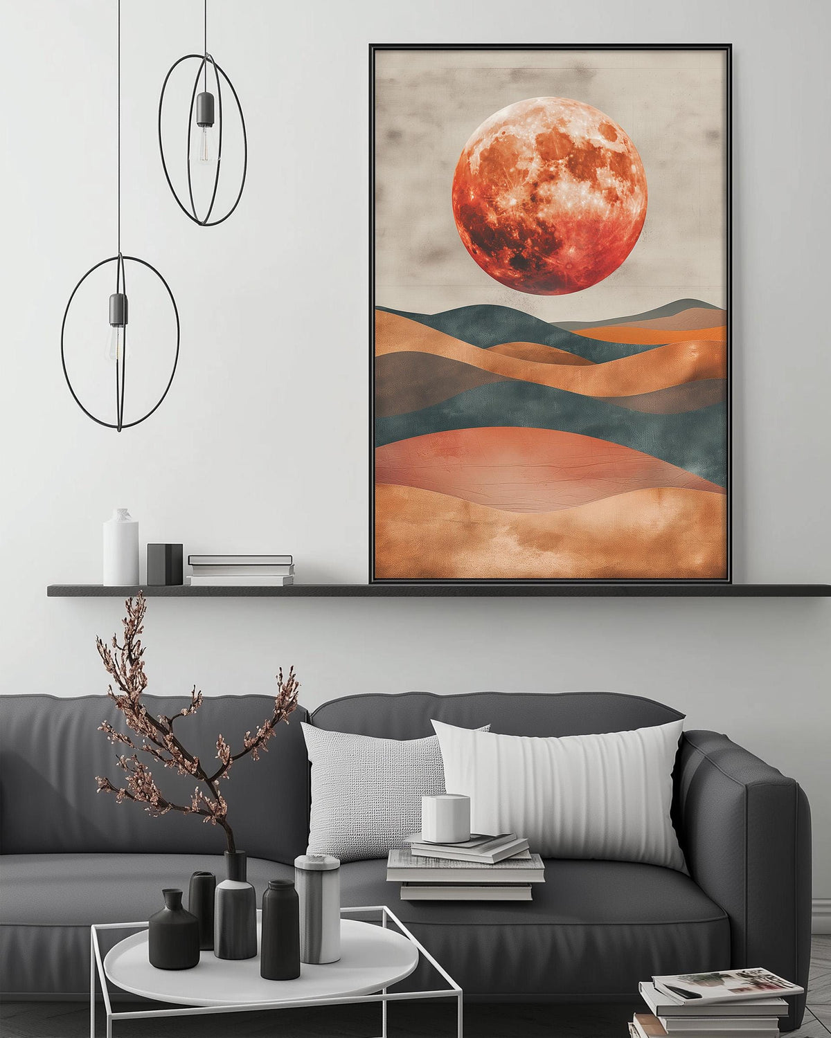 a modern living room with a gray sofa, a coffee table, and a large framed print of a landscape with a large red moon in the sky.