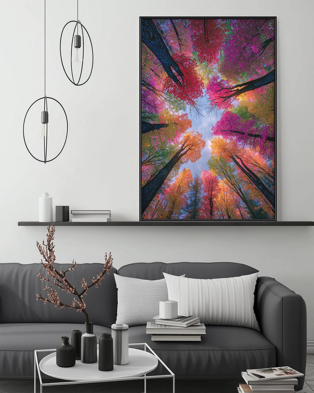 a large, colorful painting of a forest canopy with vibrant autumn foliage, hanging on a wall above a gray couch in a modern living room setting.