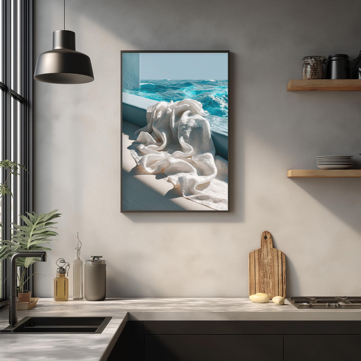 a framed photograph of a white cloth hanging on a wall, with a view of the ocean visible through a window.