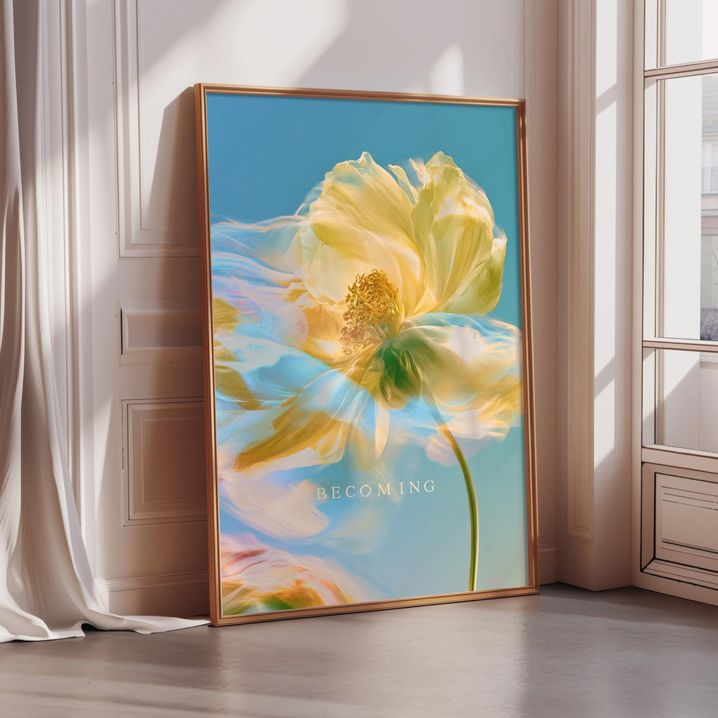 a large framed poster with a vibrant, colorful flower on it, placed on a wall near a window.