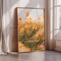 A framed photograph of a field of flowers with the text "GOLDEN DAYS" displayed on the bottom of the frame.