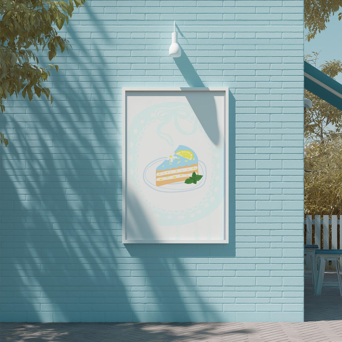 a blue brick wall with a framed illustration of a cake and a lemon on it, hanging on the wall.