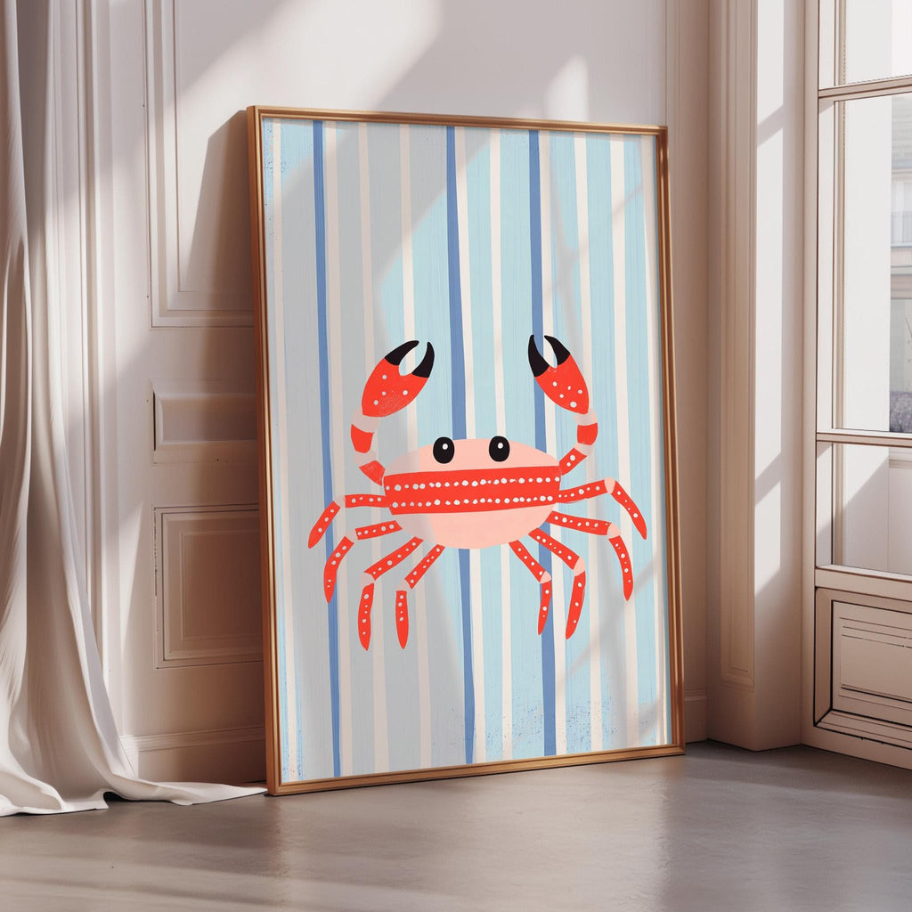 A framed illustration of a red crab with a blue and white striped background is displayed on a wall.