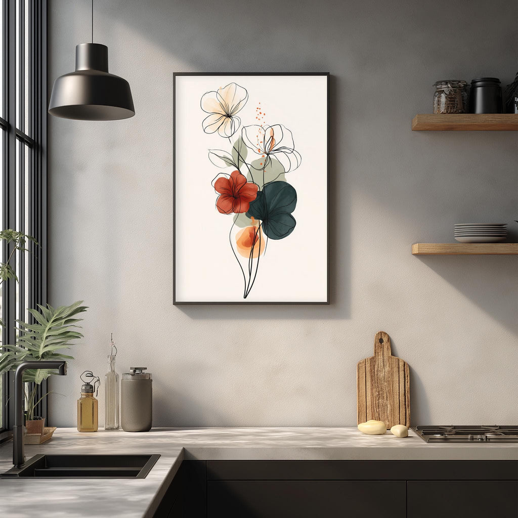 a kitchen counter with a framed floral print hanging above it, a wooden cutting board, and various kitchen accessories such as a bottle, a canister, and a bowl.
