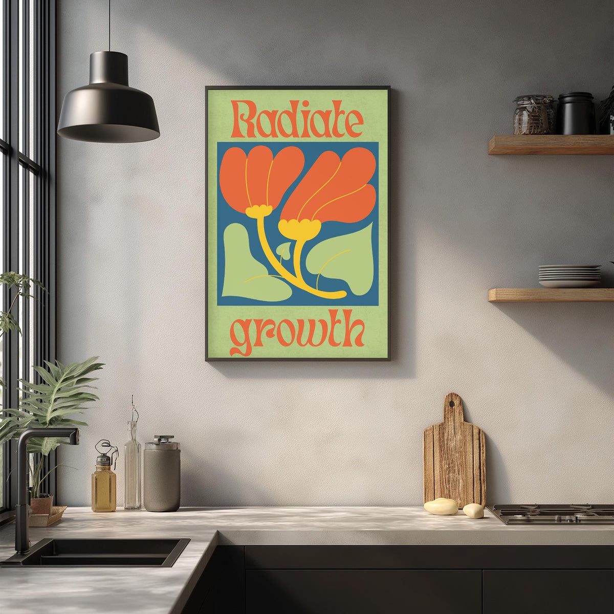 a kitchen counter with a framed poster of a flower design above it, along with various kitchen items such as a cutting board, a knife, and a bottle.