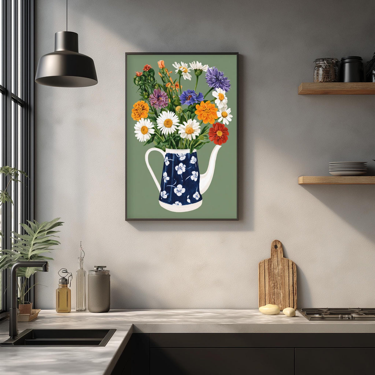 a kitchen counter with a blue and white teapot, a wooden cutting board, and various kitchen items such as a bottle, a canister, and a bowl. Above the counter, there is a framed print of a vase filled with colorful flowers, creating a lively and vibrant atmosphere in the kitchen.