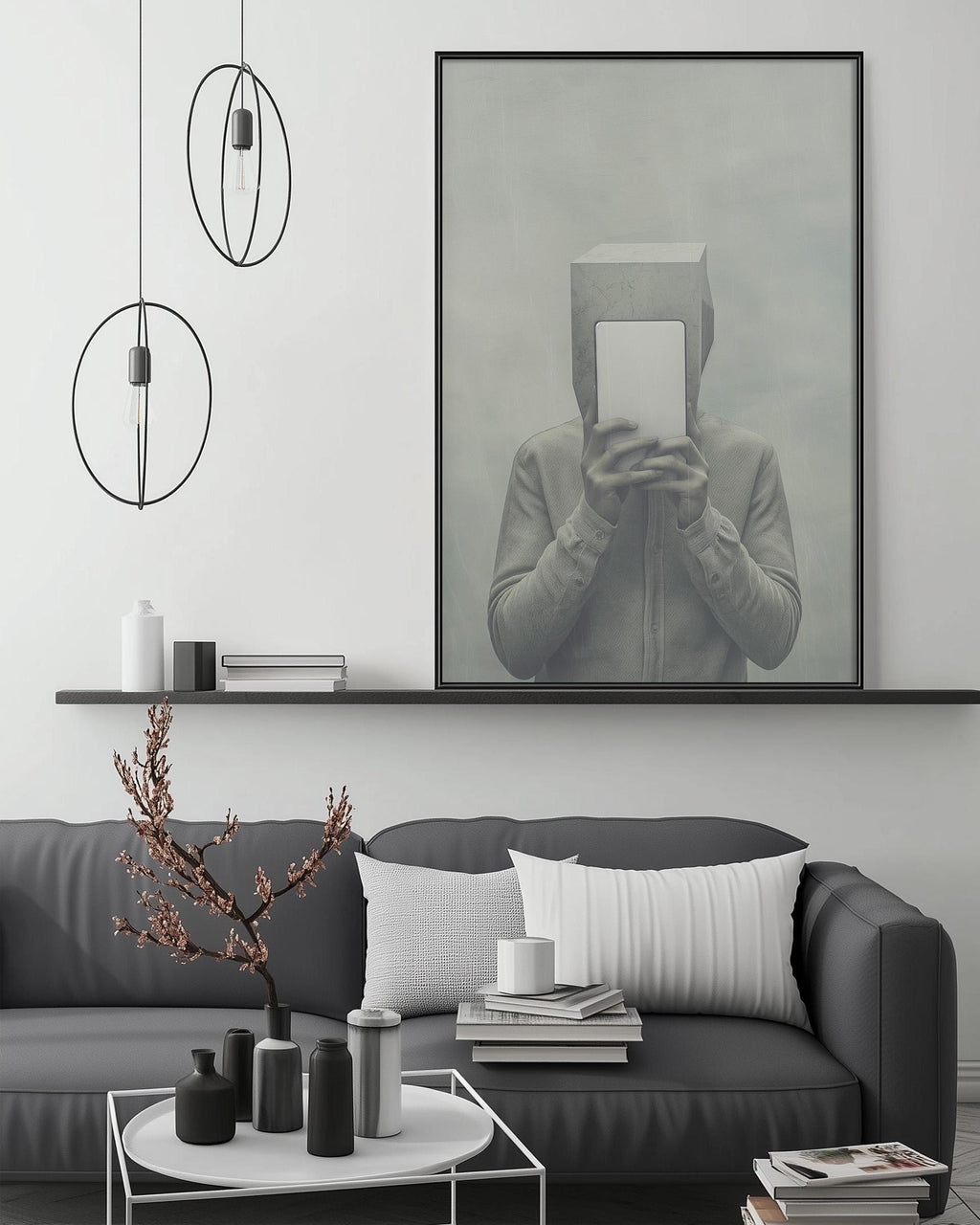 a modern living room with a gray sofa, a coffee table, and a large framed artwork depicting a person holding a box. The room has a minimalist and contemporary design, with a black and white color scheme.