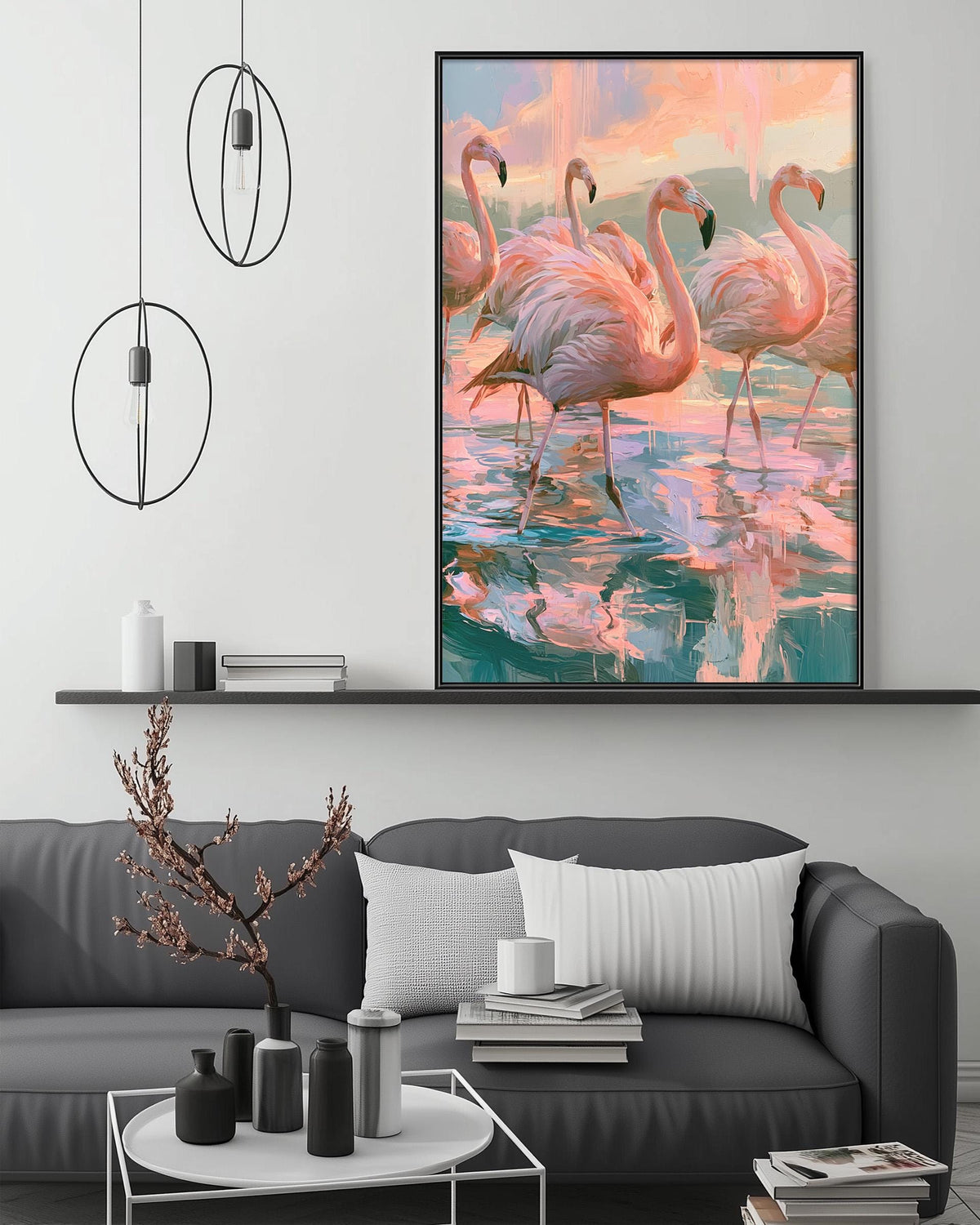 a large painting of flamingos in a serene water scene, hanging on a wall above a gray couch with a coffee table in front of it.