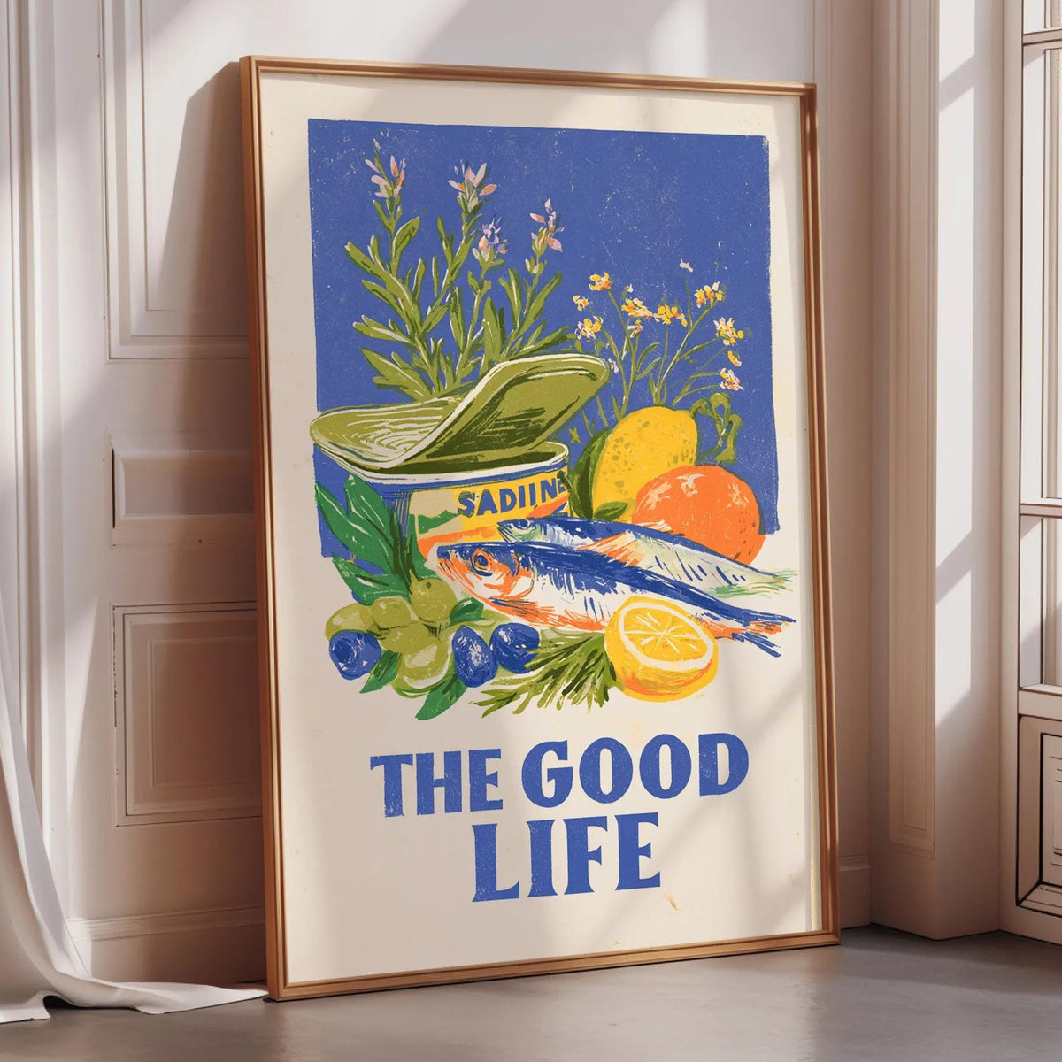 The image is a framed poster with a vibrant illustration of various fruits and vegetables, including a fish, oranges, and blueberries, along with the text "THE GOOD LIFE".