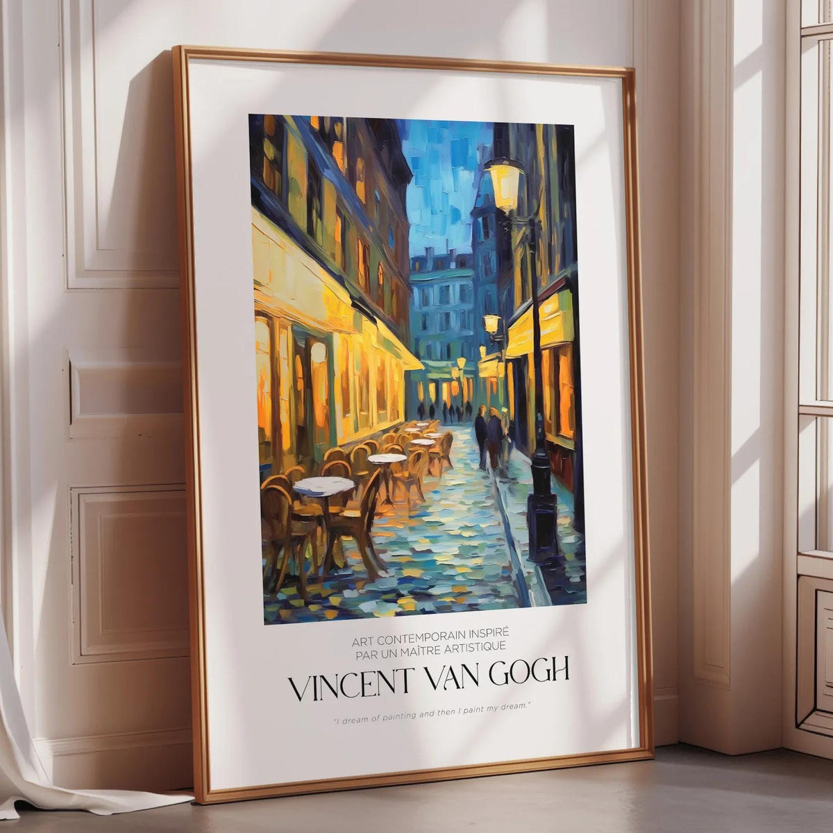 The image is a framed painting depicting a street scene with buildings, tables, and chairs.