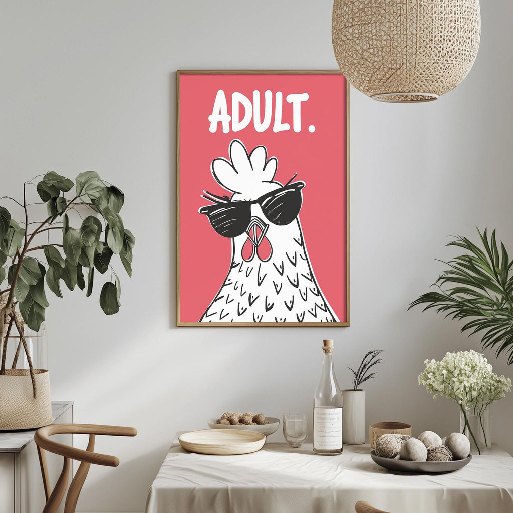 a framed poster of a rooster wearing sunglasses, hanging on a wall above a dining table with various items on it.