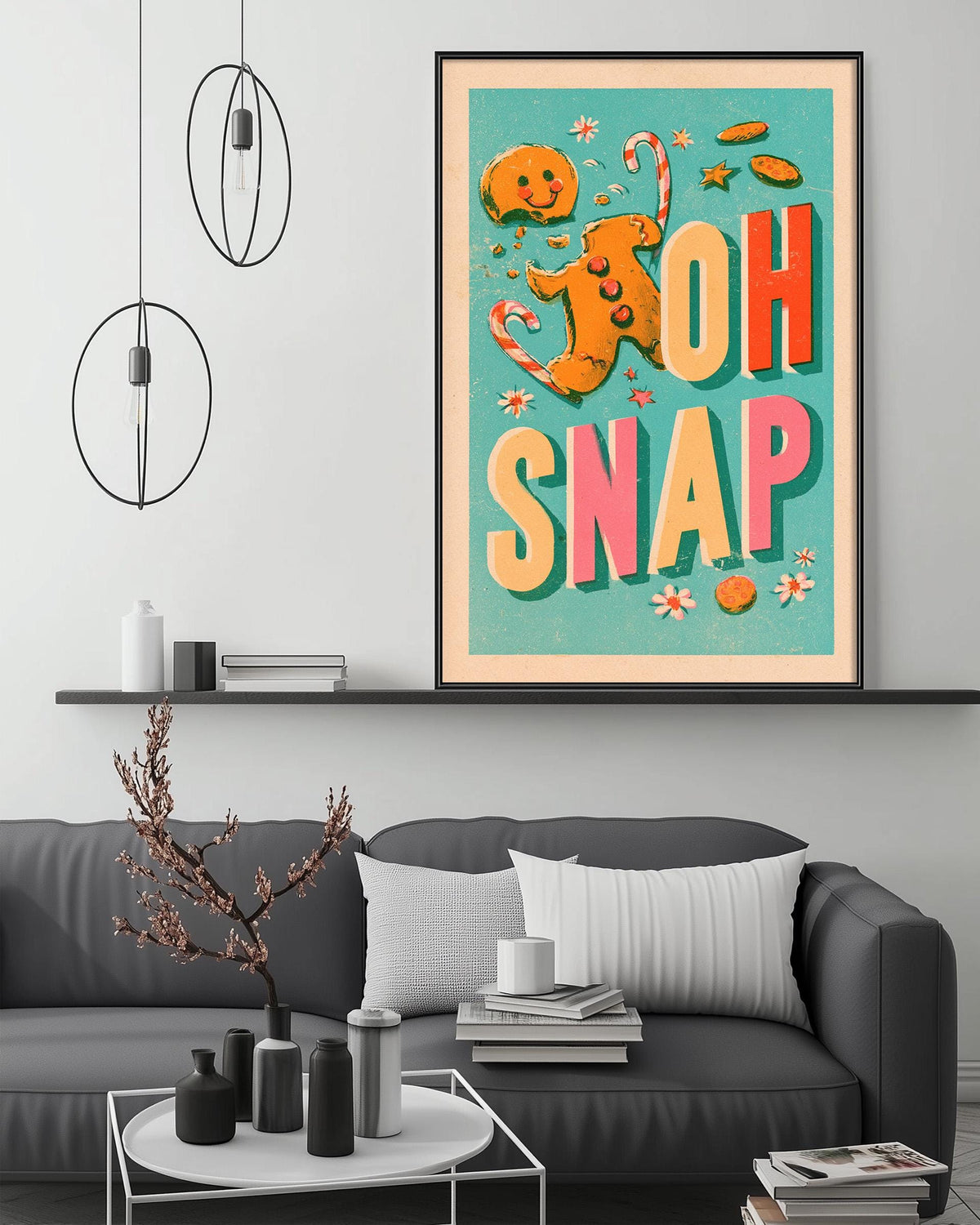 a cozy living room with a gray couch, a coffee table, and a large framed poster with a whimsical illustration of a gingerbread man and the text "OH SNAP" displayed on the wall above the couch.