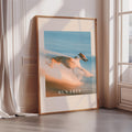 a large framed poster with a blurred dog running in the sand, with the text "RUN FREE" prominently displayed.