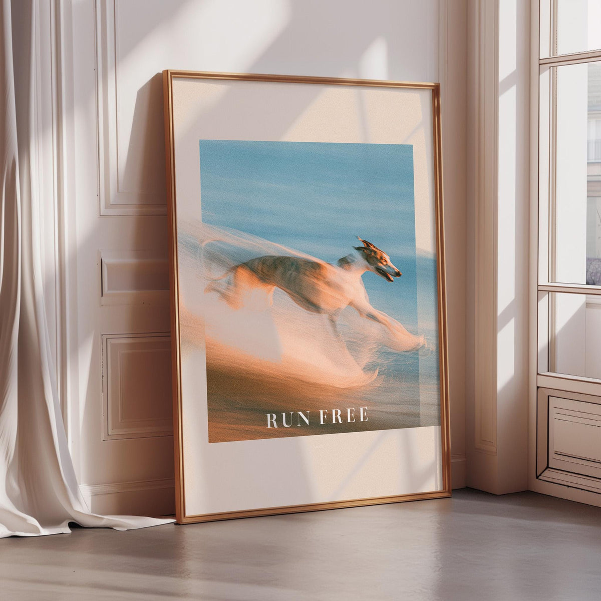 a large framed poster with a blurred dog running in the sand, with the text "RUN FREE" prominently displayed.