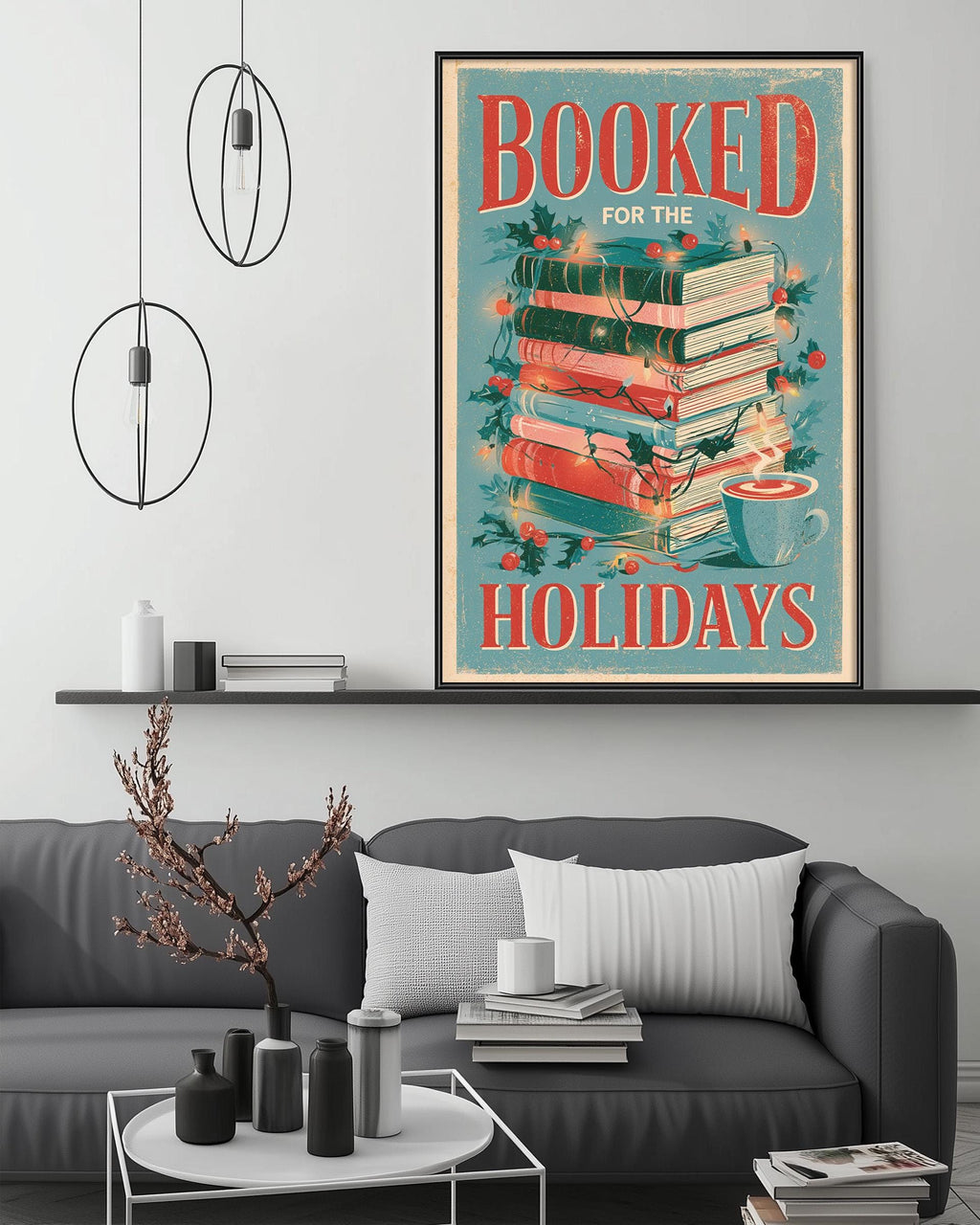 a cozy living room with a gray couch, a coffee table, and a large framed poster on the wall that reads "BOOKED FOR THE HOLIDAYS".