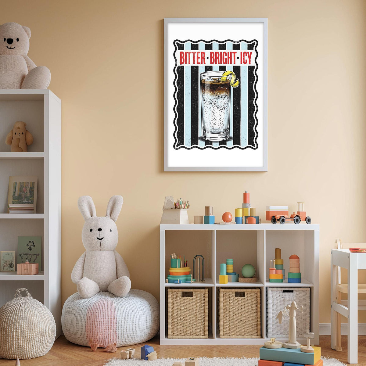 A child's bedroom with a white bookshelf, a stuffed rabbit, and a toy train. Above the bookshelf is a framed poster with the text "BITTER-BRIGHT-ICY" and an illustration of a glass of soda with a lemon slice.