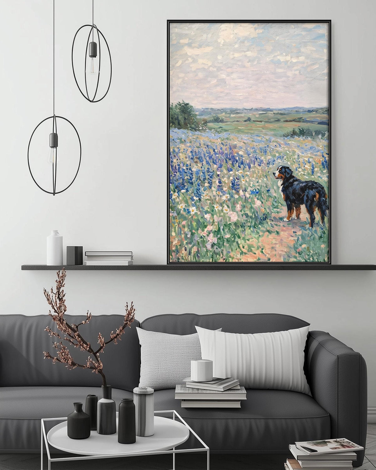 a large painting of a dog in a field of flowers hanging on a wall above a gray couch with white pillows.