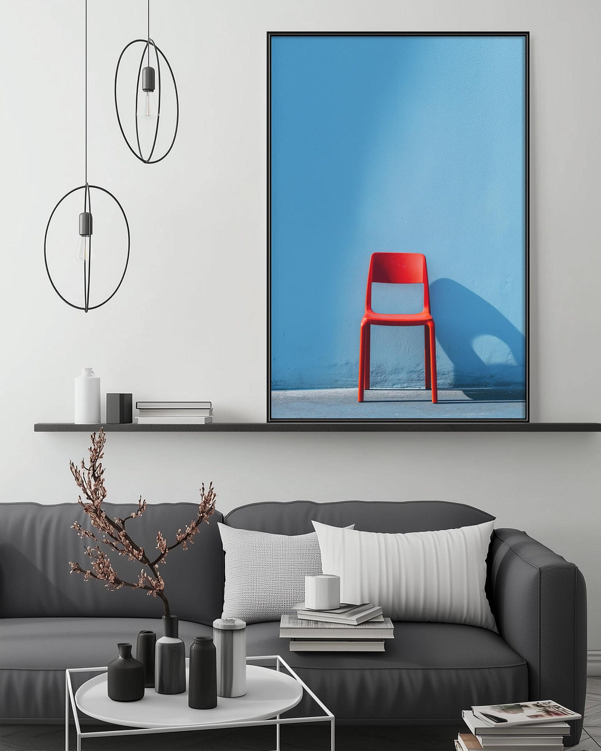 a modern living room with a gray sofa, a coffee table, and a large framed artwork of a red chair on the wall.