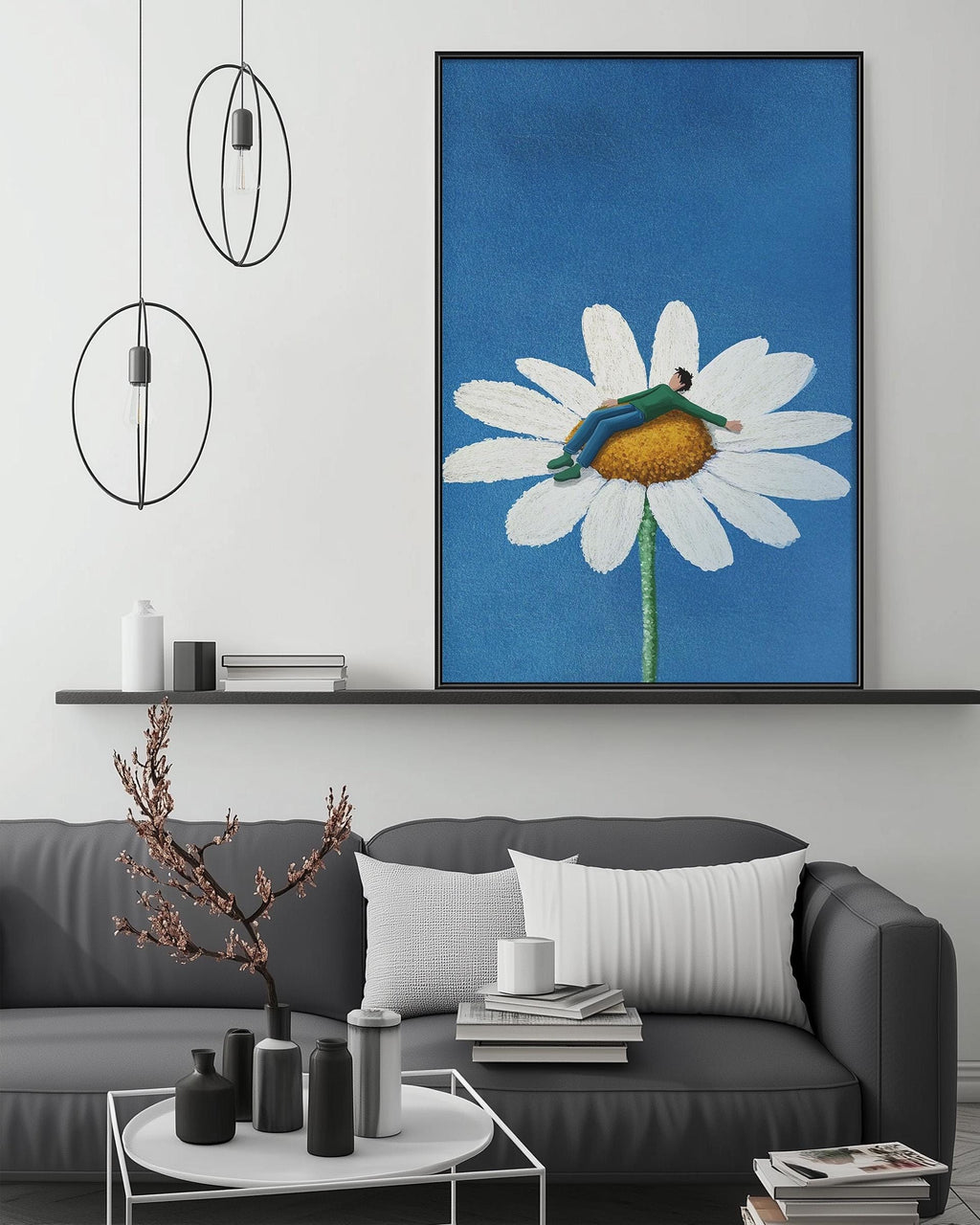 a modern living room with a gray sofa, a coffee table, and a large framed painting of a person sitting on a flower. The painting is hanging on the wall above the sofa, creating a focal point in the room.