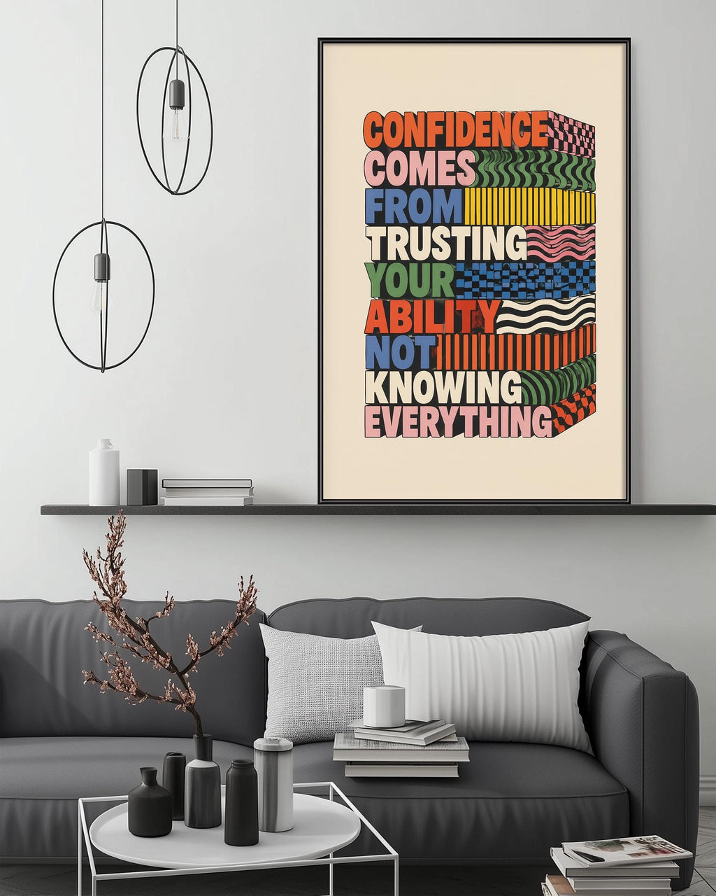 a modern living room with a gray sofa, a coffee table, and a framed motivational quote on the wall.