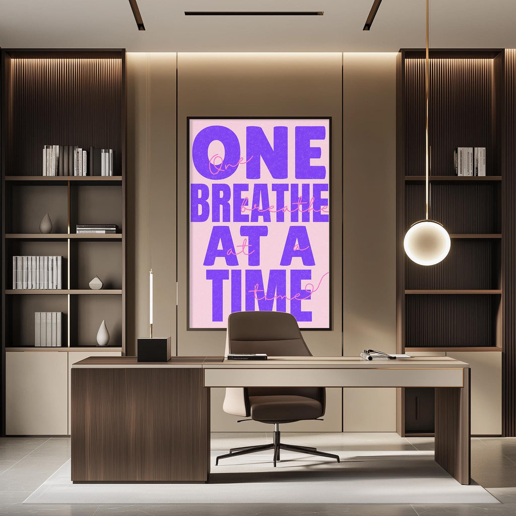 a modern office space with a large poster on the wall that reads "ONE BREATHE AT A TIME". The office has a wooden desk, a chair, and a bookshelf filled with books. The overall design and decor create a professional and comfortable atmosphere.