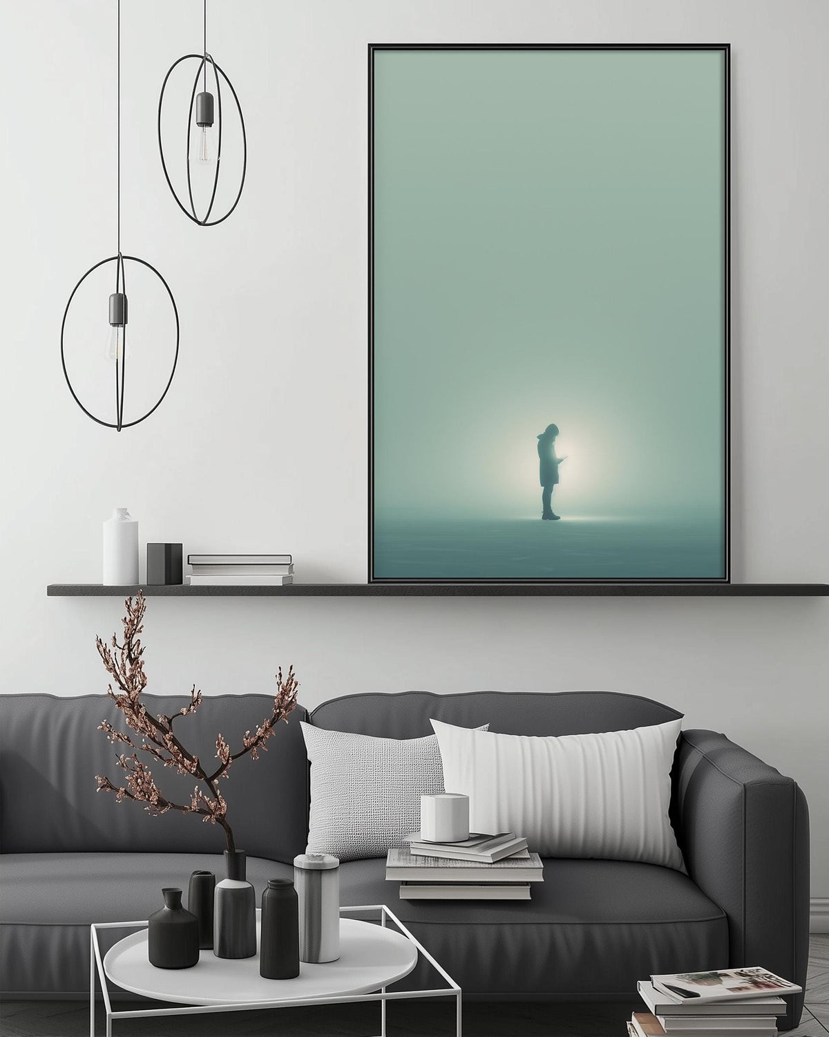a modern living room with a gray sofa, a coffee table, and a large framed artwork depicting a person standing in a foggy landscape.